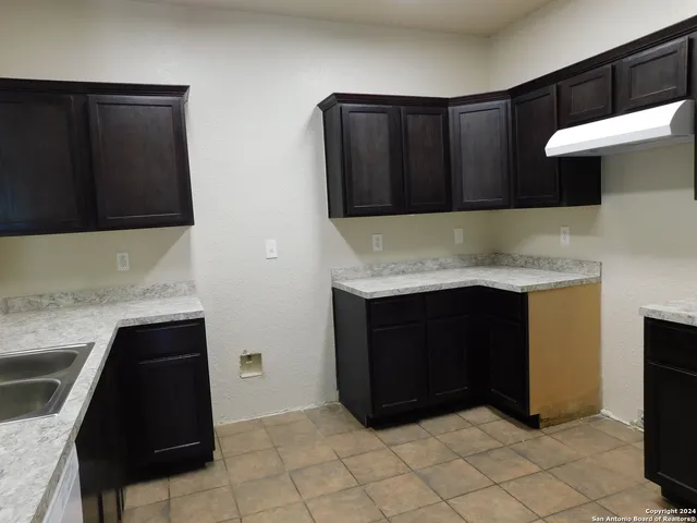 a kitchen with a cabinets and a stove