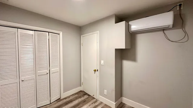 a bathroom with a glass shower door mirror and a window
