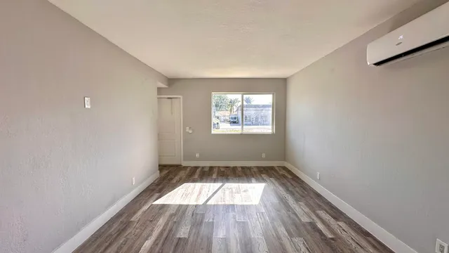 wooden floor in an empty room with a window