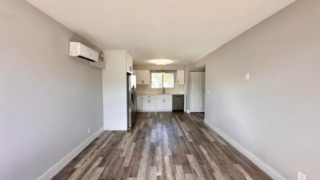 a view of a room with wooden floor and windows