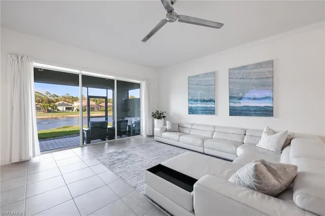 a living room with furniture and a view of kitchen