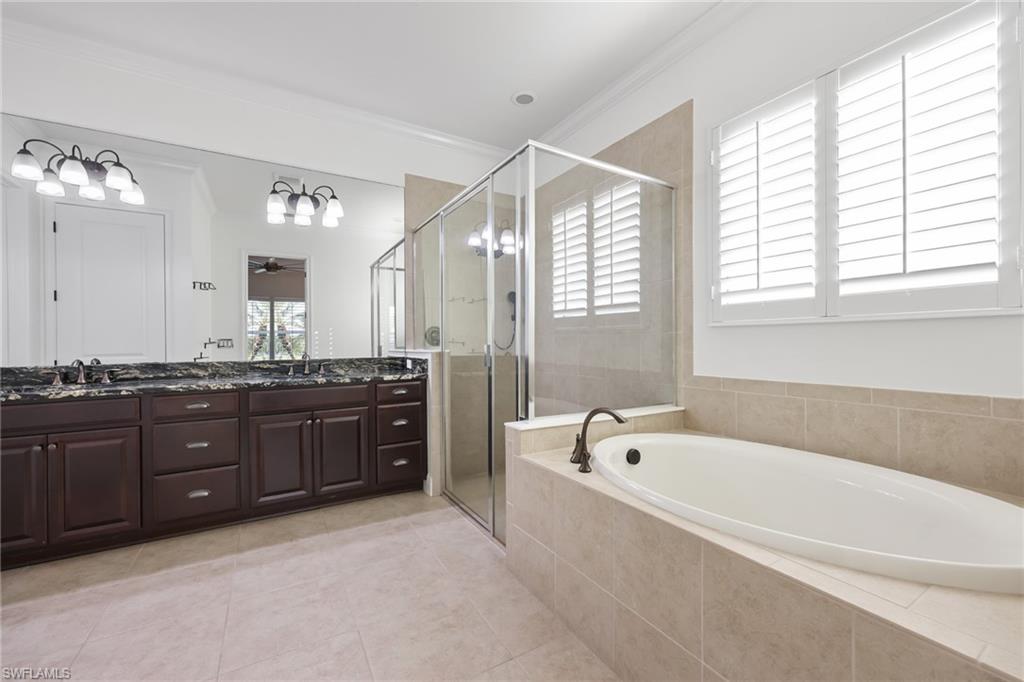 3275 Pilot Circle Naples, FL 34120 - Photo 20 of 44 a spacious bathroom with a granite countertop tub sink shower and mirror