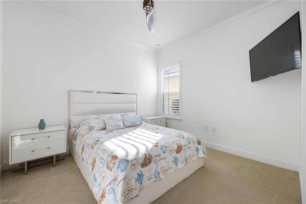 3275 Pilot Circle Naples, FL 34120 - Photo 23 of 44 a bedroom with a bed and a flat screen tv