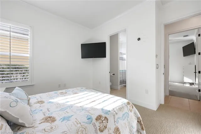 a bedroom with a bed and a flat screen tv in kitchen