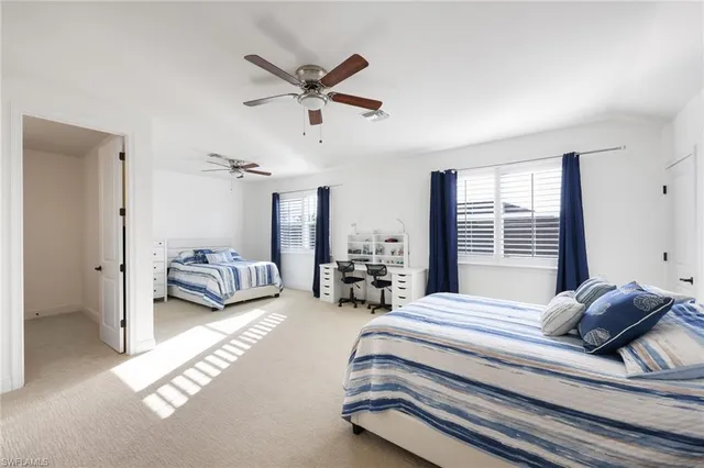 a spacious bedroom with a bed and a chandelier