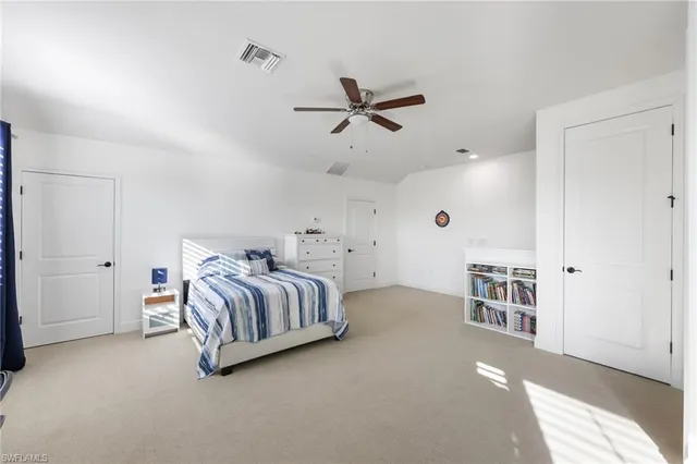 a patio with lawn chairs and a floor to ceiling window
