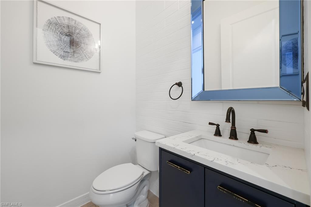 3275 Pilot Circle Naples, FL 34120 - Photo 31 of 44 a bathroom with a toilet a sink and mirror