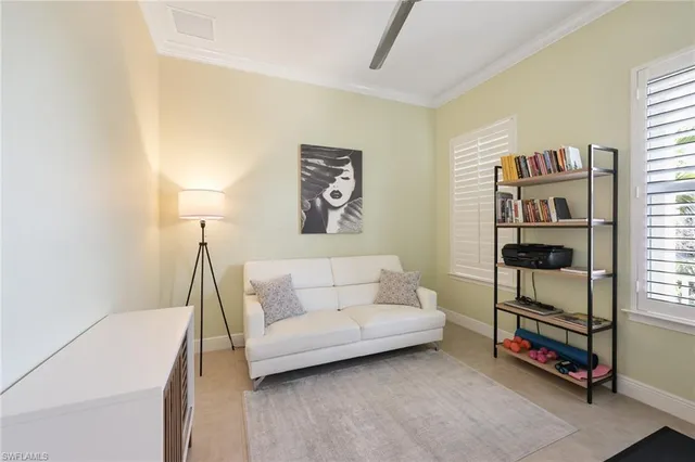 a living room with furniture and a baby crib