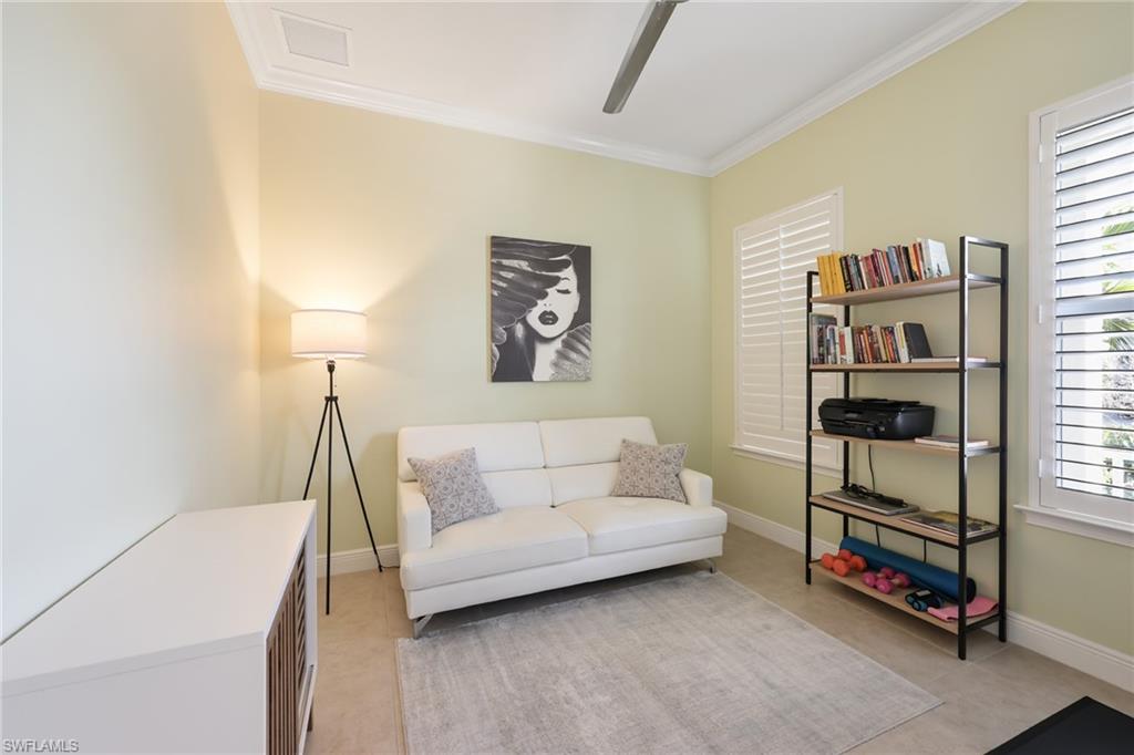 3275 Pilot Circle Naples, FL 34120 - Photo 6 of 44 a living room with furniture and a baby crib