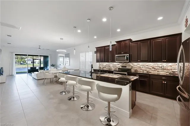 a kitchen with stainless steel appliances granite countertop a stove and a sink
