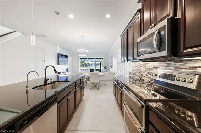 a kitchen with stainless steel appliances granite countertop a sink and stove