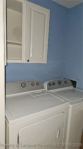 a view of storage and utility room with washer and dryer
