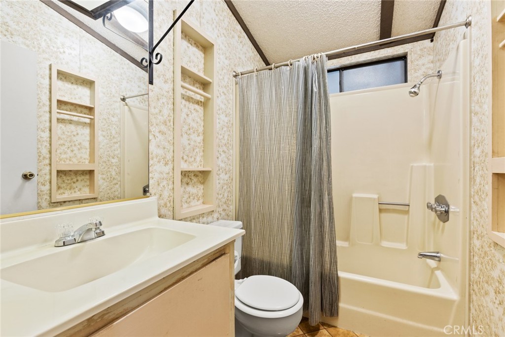 3835 Gardiner Ferry Road, Unit 4 Corning, CA 96021 - Photo 17 of 22 a bathroom with a granite countertop sink toilet and shower