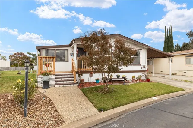 a view of a house with a tree in the background