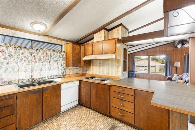 a kitchen with a sink stove and cabinets