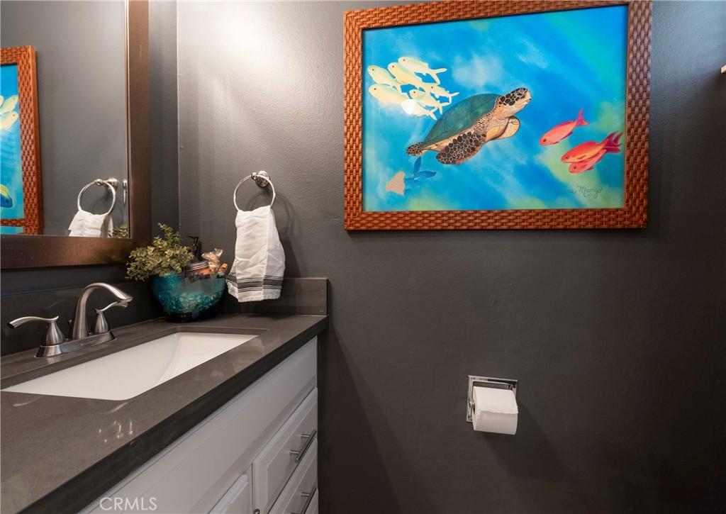 5481 Peacock Lane Riverside, CA 92505 - Photo 20 of 69 a bathroom with a sink mirror and vanity