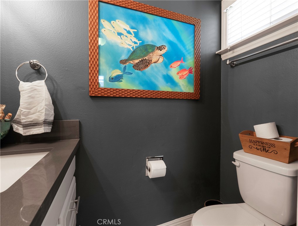 5481 Peacock Lane Riverside, CA 92505 - Photo 21 of 69 a bathroom with a toilet and a picture on the wall