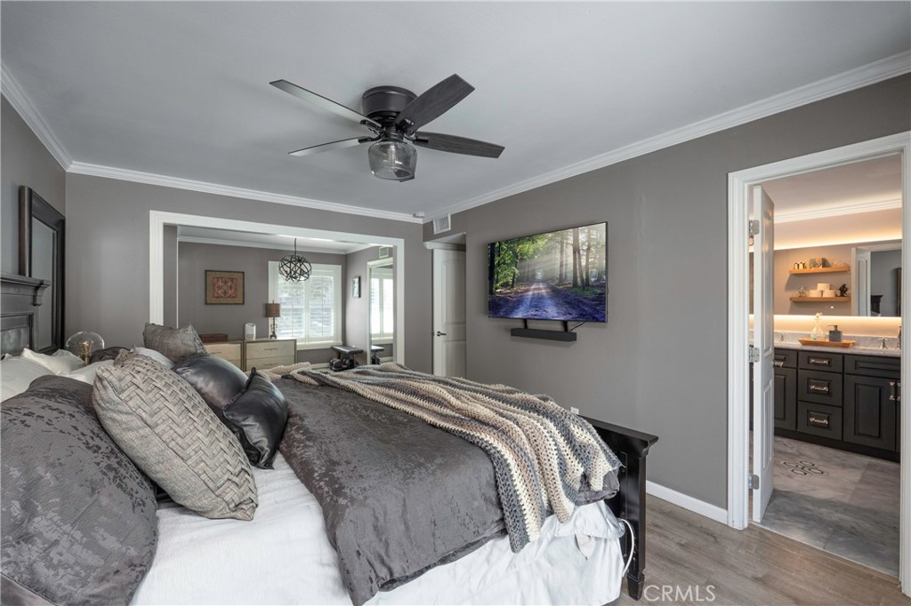 5481 Peacock Lane Riverside, CA 92505 - Photo 26 of 69 a bedroom with a large bed and a chandelier