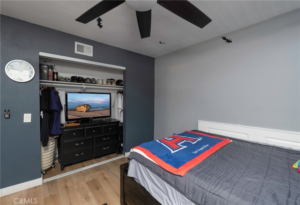 5481 Peacock Lane Riverside, CA 92505 - Photo 36 of 69 a bedroom with a bed and a flat tv screen