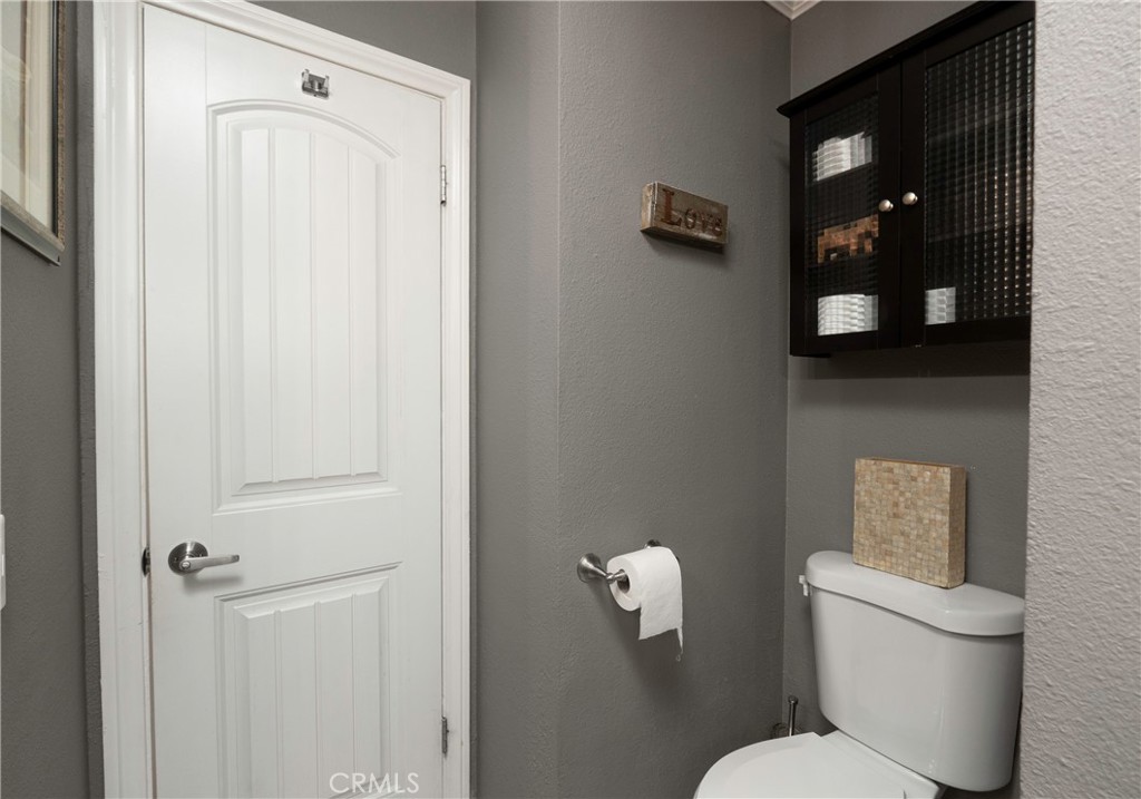 5481 Peacock Lane Riverside, CA 92505 - Photo 39 of 69 a white toilet sitting next to a bathroom sink and vanity