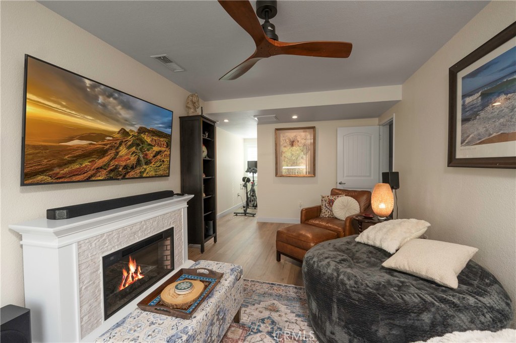 5481 Peacock Lane Riverside, CA 92505 - Photo 43 of 69 a living room with furniture a flat screen tv and a fireplace