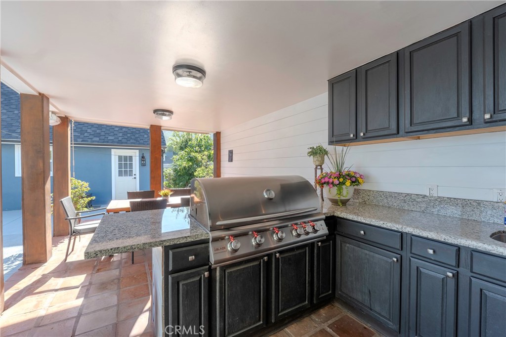 5481 Peacock Lane Riverside, CA 92505 - Photo 52 of 69 a kitchen with granite countertop a stove top oven cabinetry a sink and dishwasher