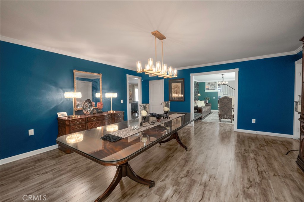 5481 Peacock Lane Riverside, CA 92505 - Photo 10 of 69 a view of a dining room with furniture a chandelier and wooden floor