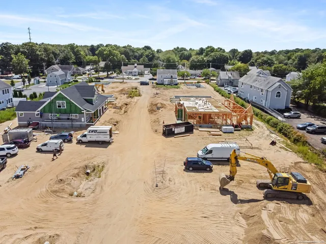 an aerial view of a residential building with an outdoor space