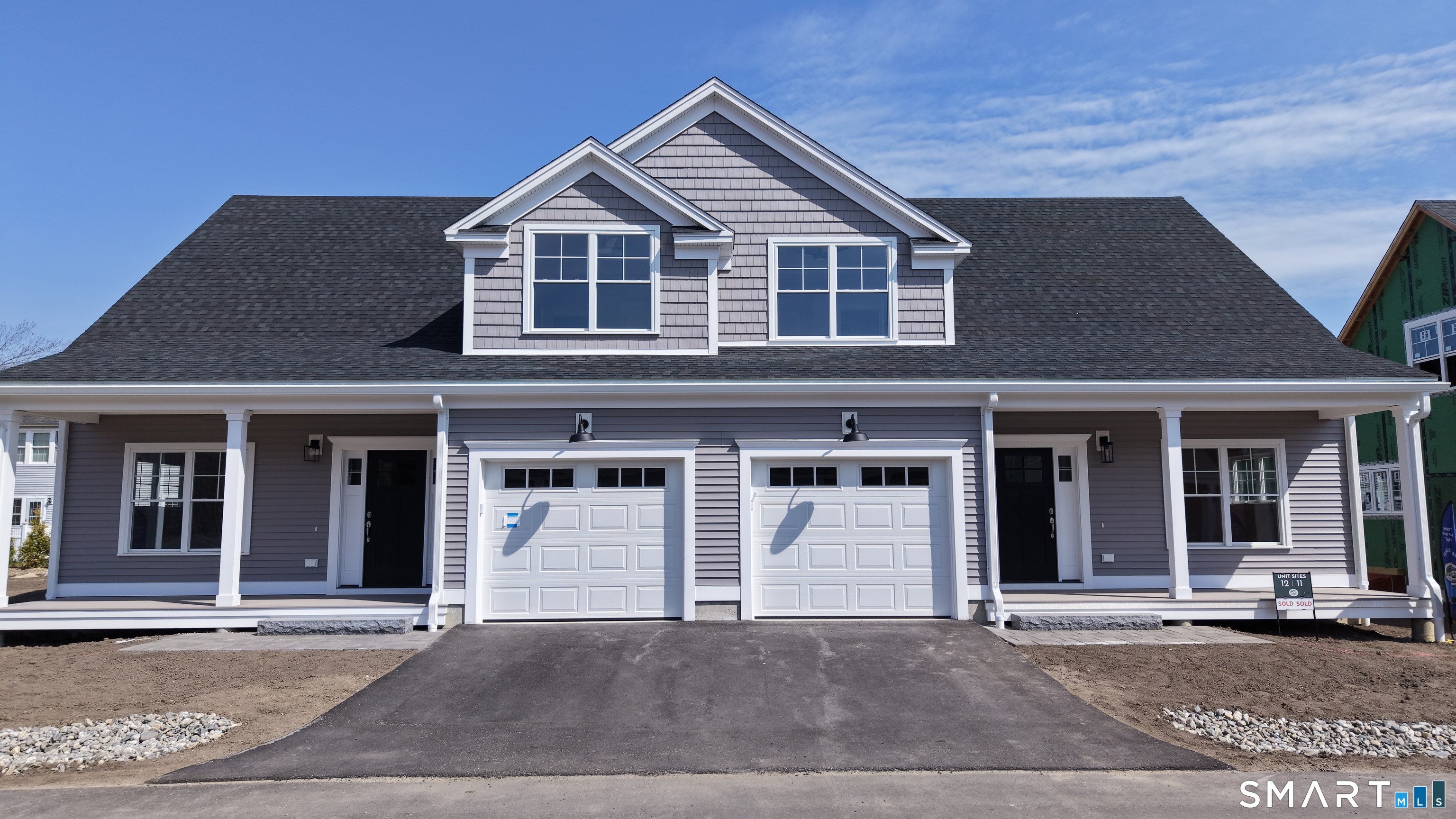 151-153 East Main Street, Unit 16 Clinton, CT 06413 - Photo 23 of 32 a front view of a house with a garage