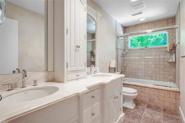 a spacious bedroom with a bed and window