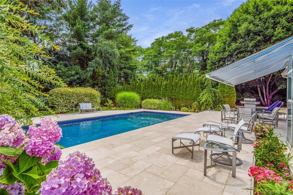 a swimming pool with outdoor seating and yard