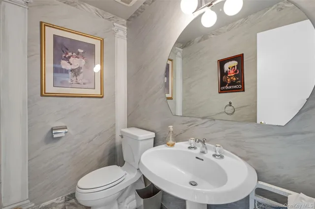 a bathroom with a toilet a sink and mirror