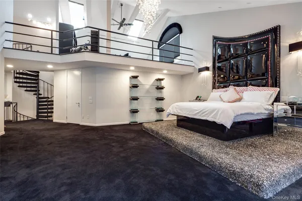 a bedroom with a bed and dresser with mirror