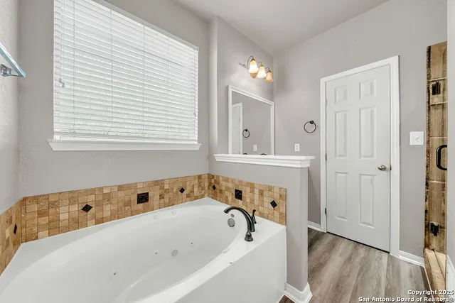a bathroom with a bathtub and a window