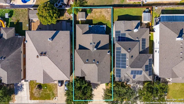 an aerial view of residential houses with outdoor space