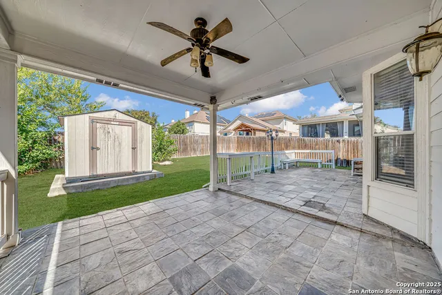 a view of a porch with a table and chairs