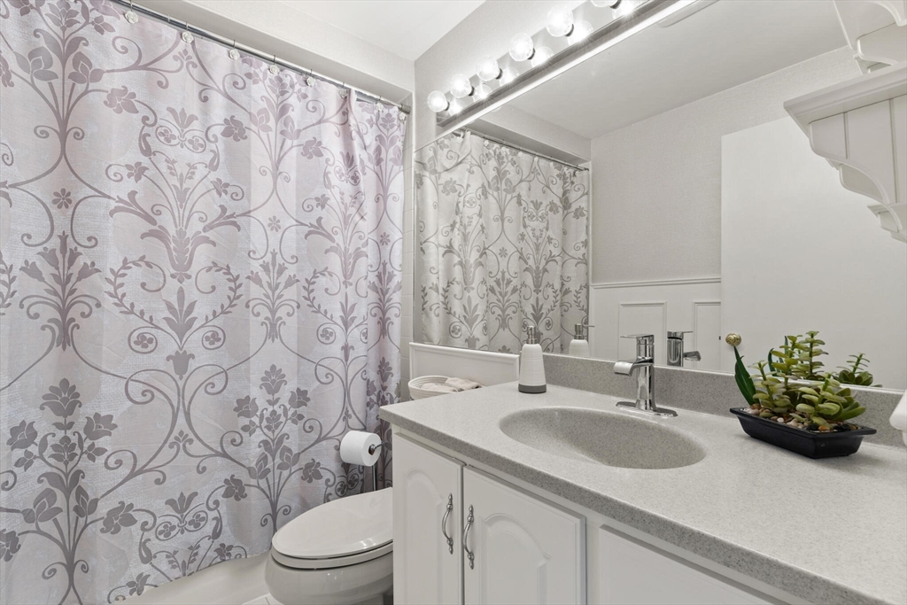 25 Bellflower Road Billerica, MA 01821 - Photo 11 of 40 a bathroom with a sink toilet and a mirror