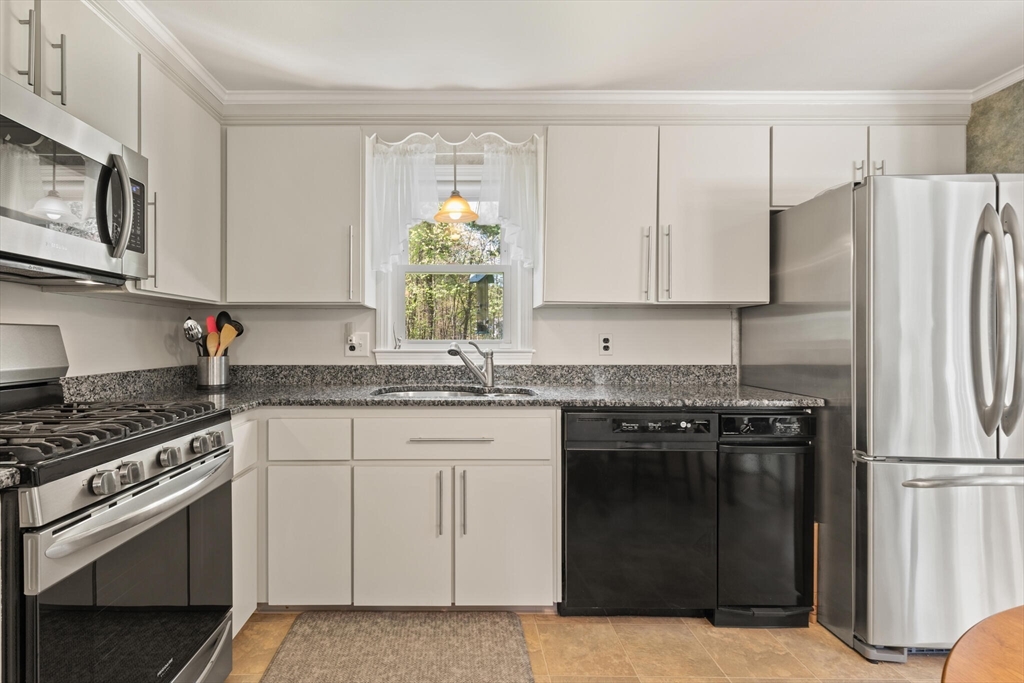 25 Bellflower Road Billerica, MA 01821 - Photo 14 of 40 a kitchen with granite countertop a stove sink and refrigerator