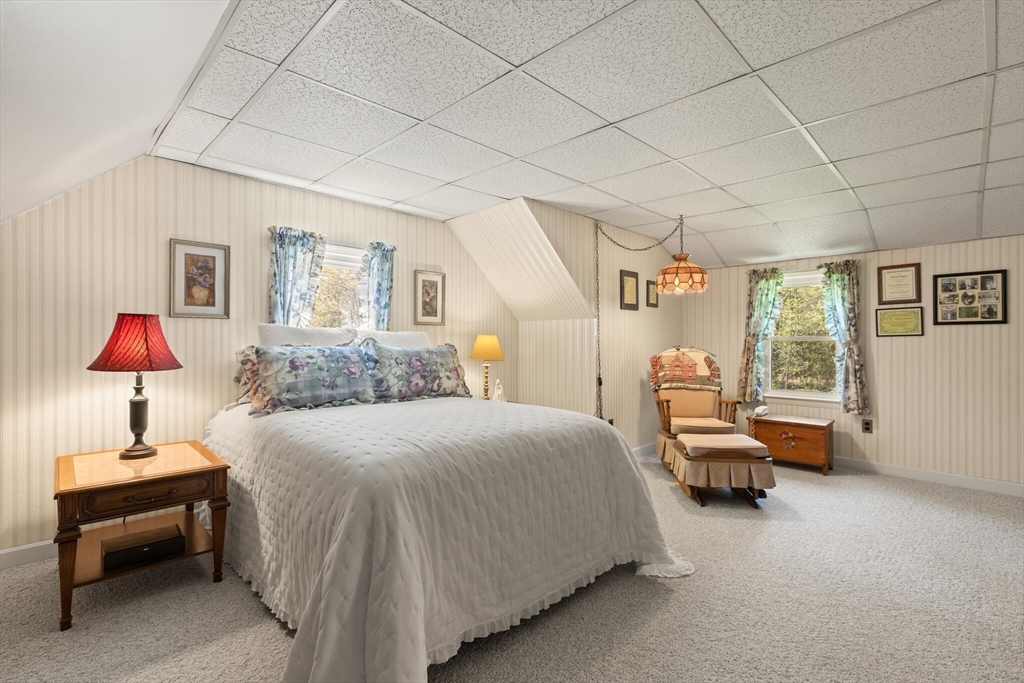25 Bellflower Road Billerica, MA 01821 - Photo 25 of 40 a bedroom with a bed and a lamp