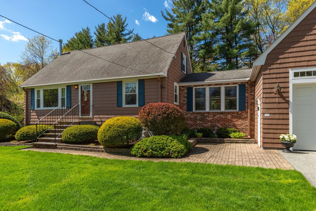 25 Bellflower Road Billerica, MA 01821 - Photo 5 of 40 a front view of a house with a garden and plants