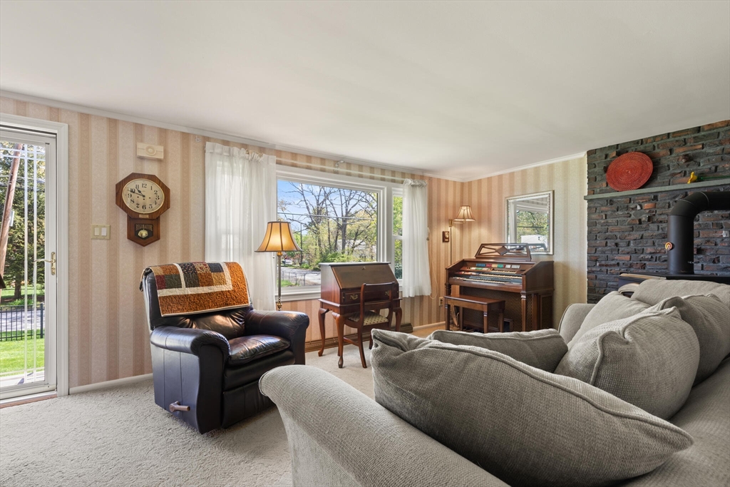 25 Bellflower Road Billerica, MA 01821 - Photo 8 of 40 a living room with furniture a fireplace and a window