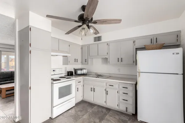 a kitchen with cabinets stainless steel appliances and a window