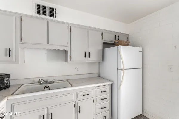 a white refrigerator freezer sitting inside of a kitchen