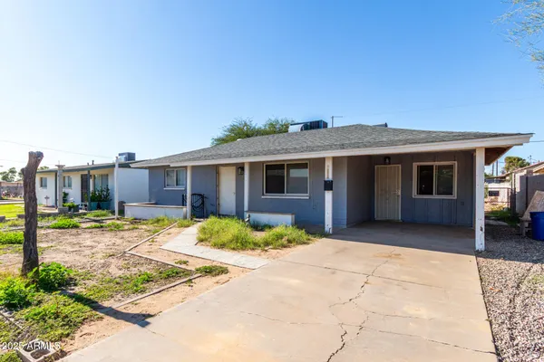 a front view of a house with a garden