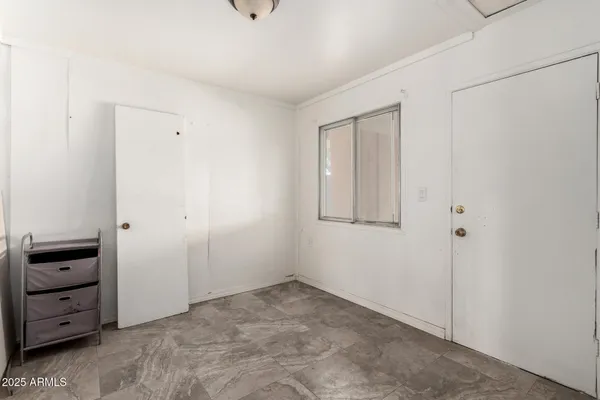 a view of a closet area with ceiling fan