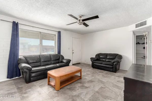 a living room with furniture and a piano