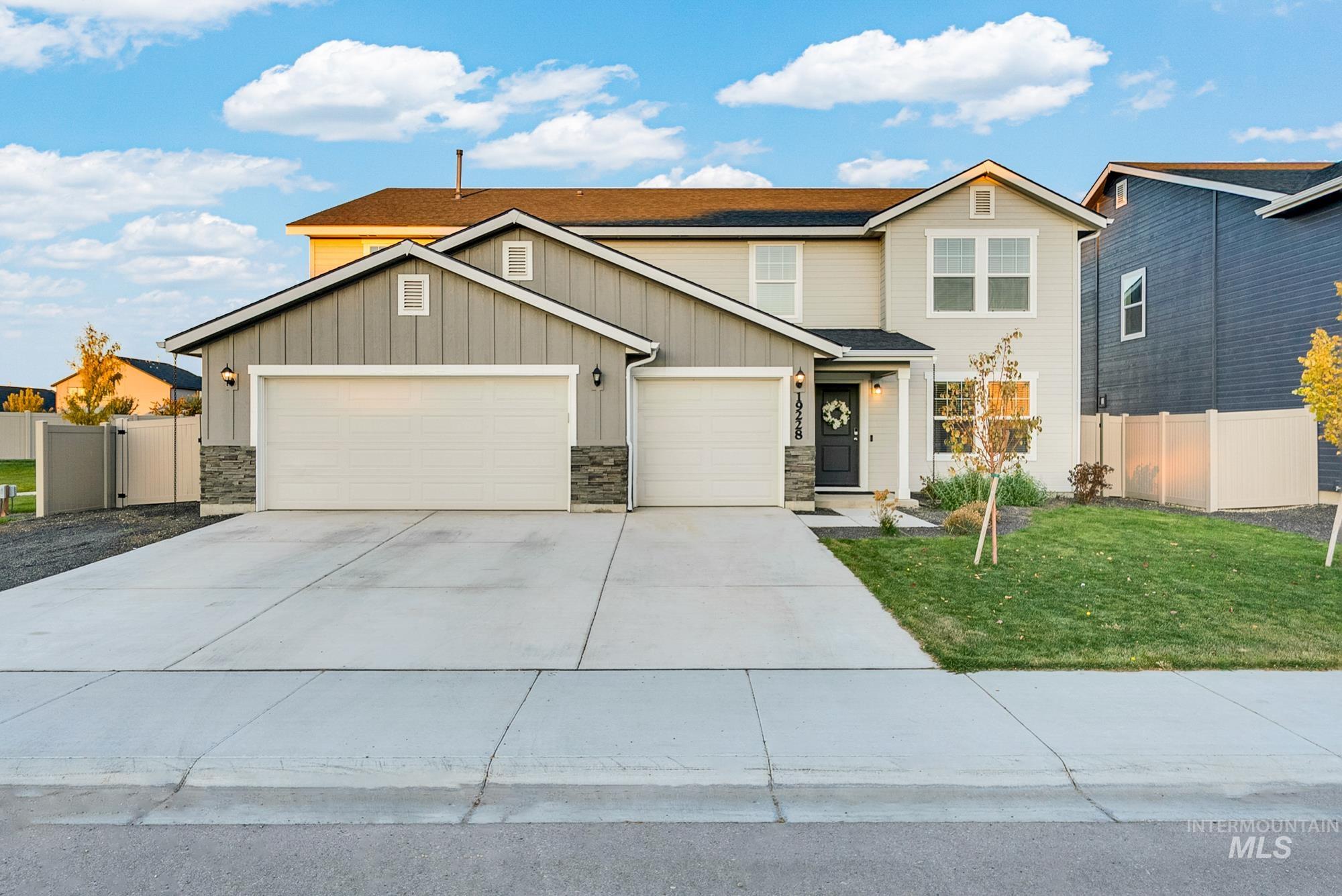 19228 Ralston Way Caldwell, ID 83605 - Photo 1 of 1 View of front of house with board and batten siding, driveway, stone siding, and an attached garage