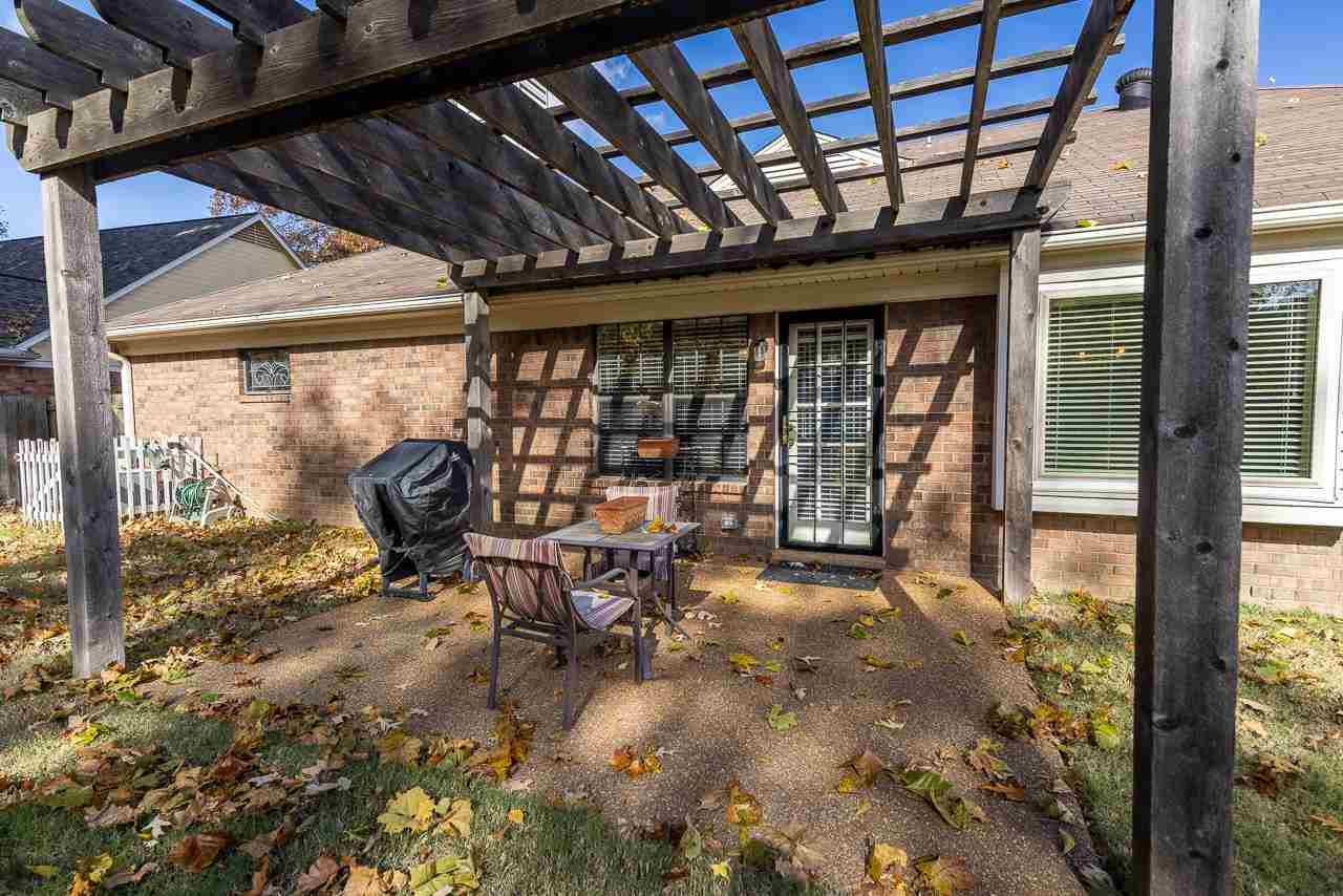 297 East White Road Collierville, TN 38017 - Photo 20 of 20 a view of a porch with a table and chairs
