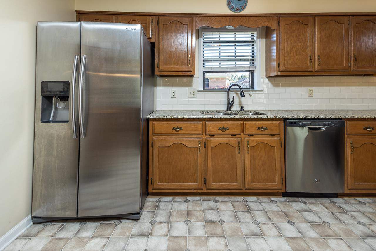 297 East White Road Collierville, TN 38017 - Photo 7 of 20 a kitchen with stainless steel appliances granite countertop a refrigerator a sink and dishwasher