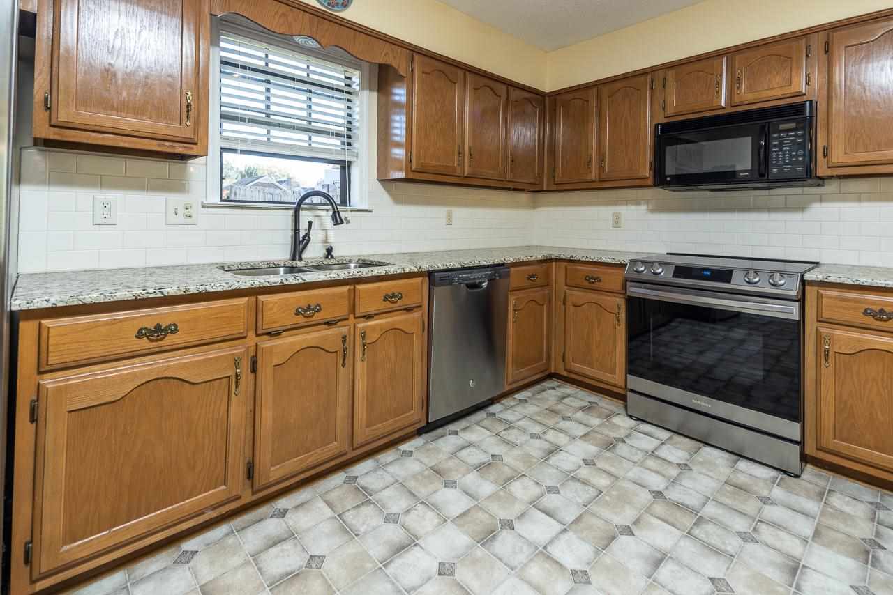 297 East White Road Collierville, TN 38017 - Photo 8 of 20 a kitchen with stainless steel appliances granite countertop a stove microwave and sink